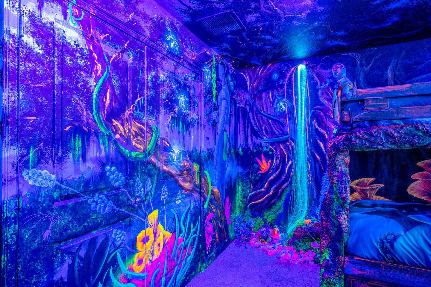Blacklight mural wall with fiber-optic waterfall detail in the Avatar-inspired b