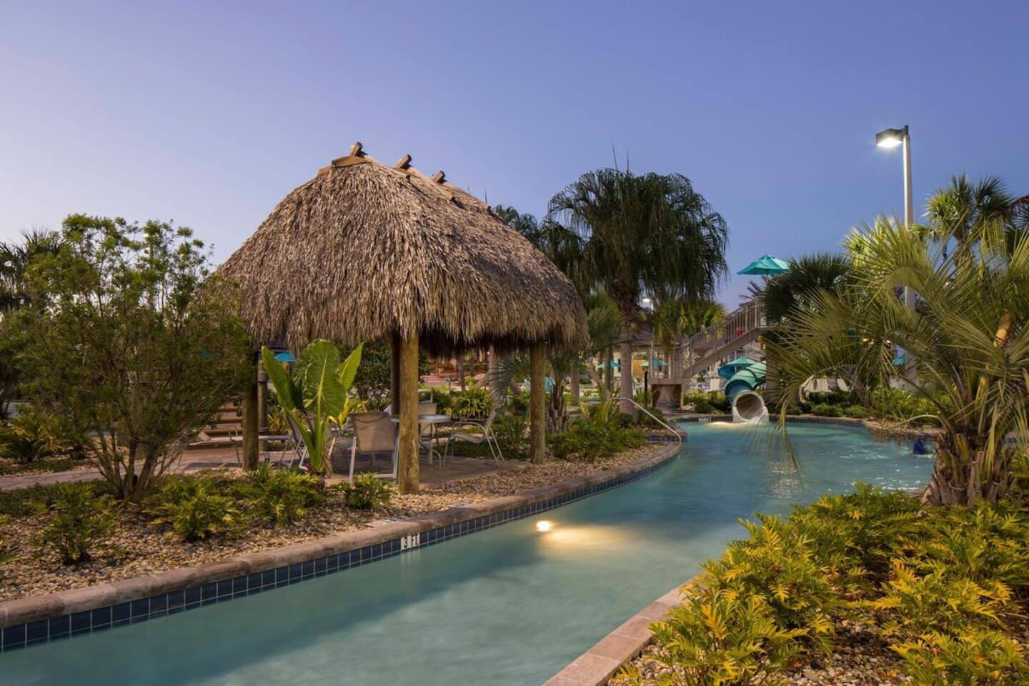 Tropical Oasis: Serene poolside retreat with thatched cabana and lush landscapin